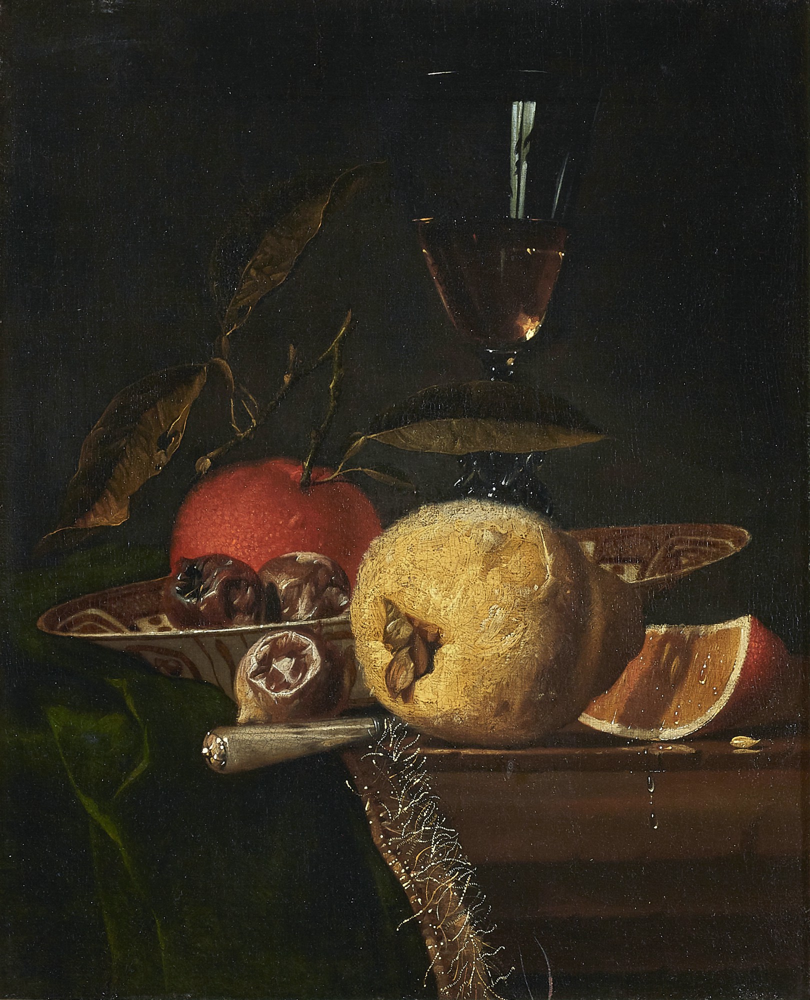 HENDRICK VAN STREECK | STILL LIFE WITH A QUINCE, ORANGE AND OTHER FRUIT ON A PARTLY DRAPED LEDGE WITH CHINESE PORCELAIN AND A GLASS OF WINE