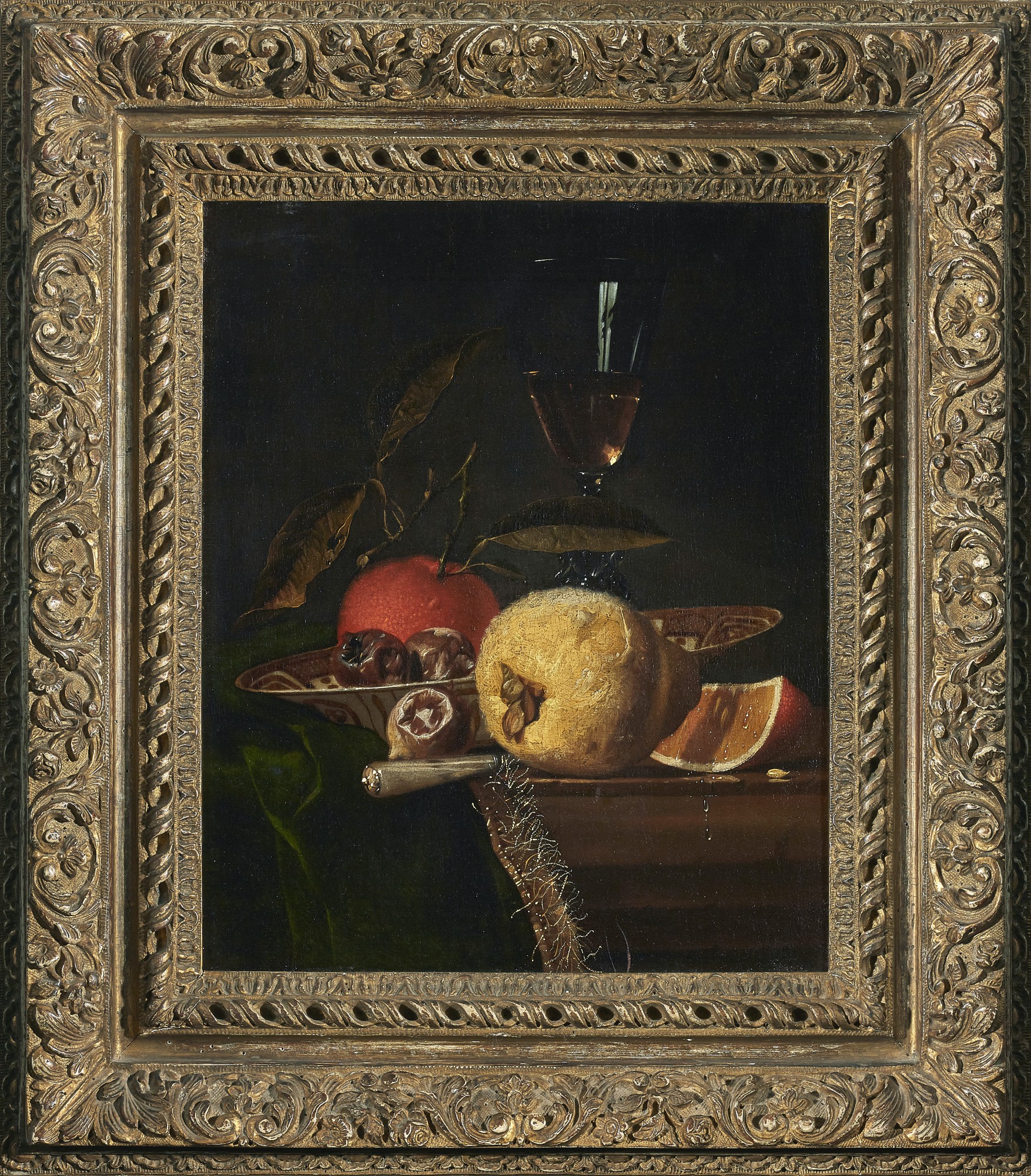 HENDRICK VAN STREECK | STILL LIFE WITH A QUINCE, ORANGE AND OTHER FRUIT ON A PARTLY DRAPED LEDGE WITH CHINESE PORCELAIN AND A GLASS OF WINE